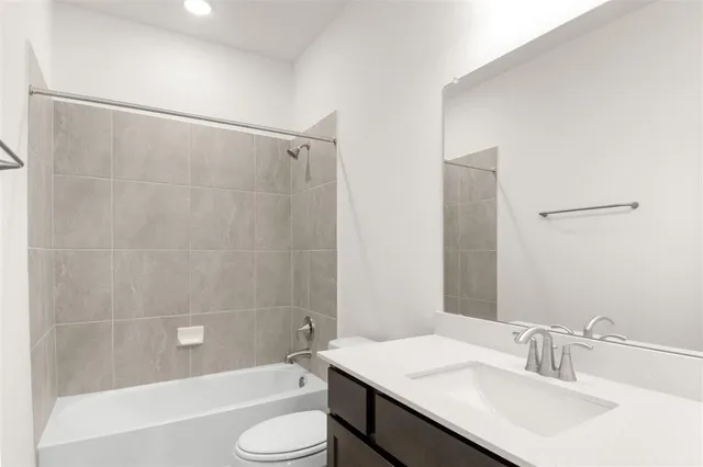 a bathroom with a shower sink and mirror
