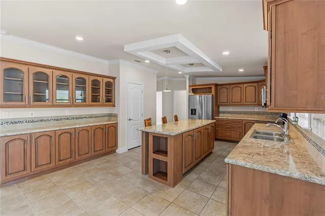 an empty room with a chandelier fan