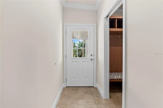 an empty room with a window and ceiling fan