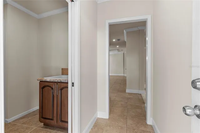 an empty room with a ceiling fan and window