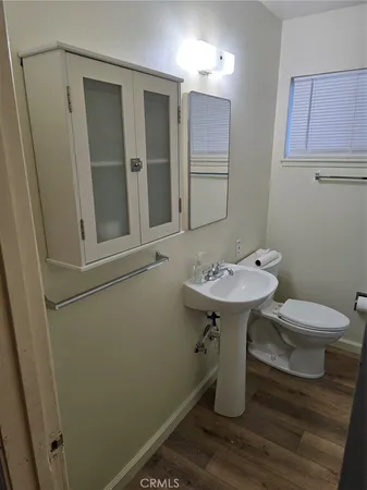 a bathroom with a sink toilet and a mirror
