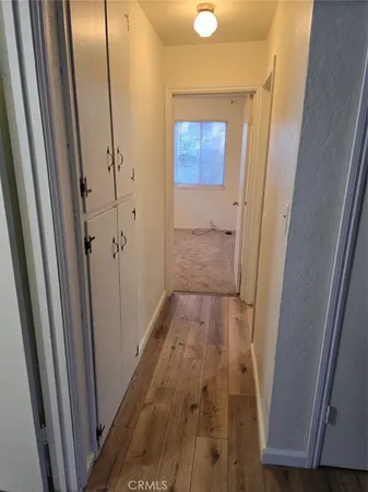 a view of hallway with wooden floor