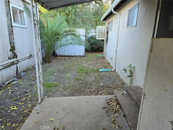 a backyard of a house with a fountain