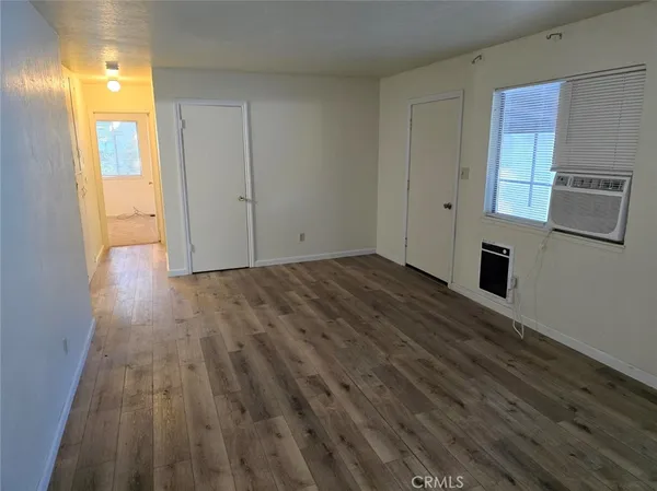 a view of a kitchen with wooden floor and a sink