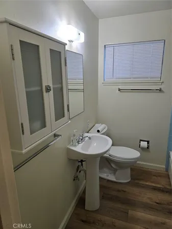 a bathroom with a sink toilet and mirror