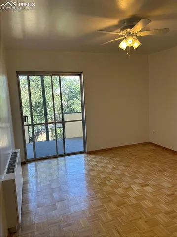 a view of room with window and a ceiling fan