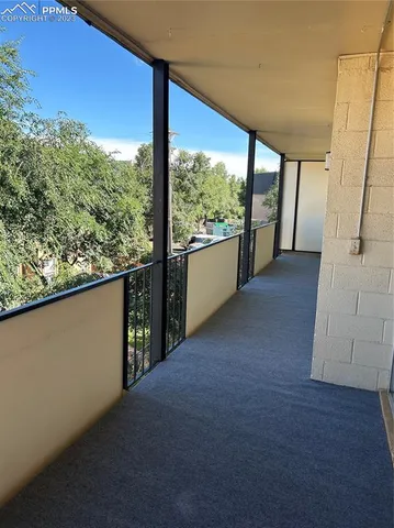wooden floor in an empty room with a large window