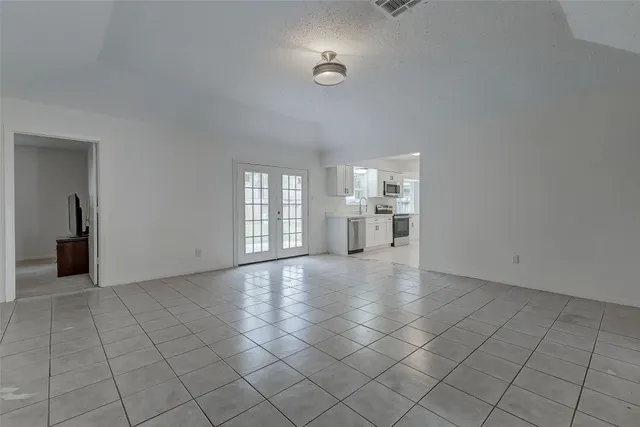 a kitchen with white cabinets and white appliances
