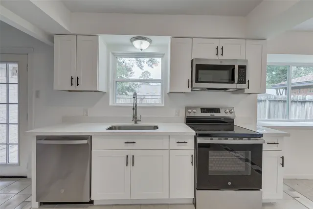 a room with a stove and a refrigerator