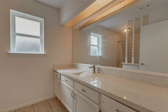 a bathroom with a shower a toilet and a sink