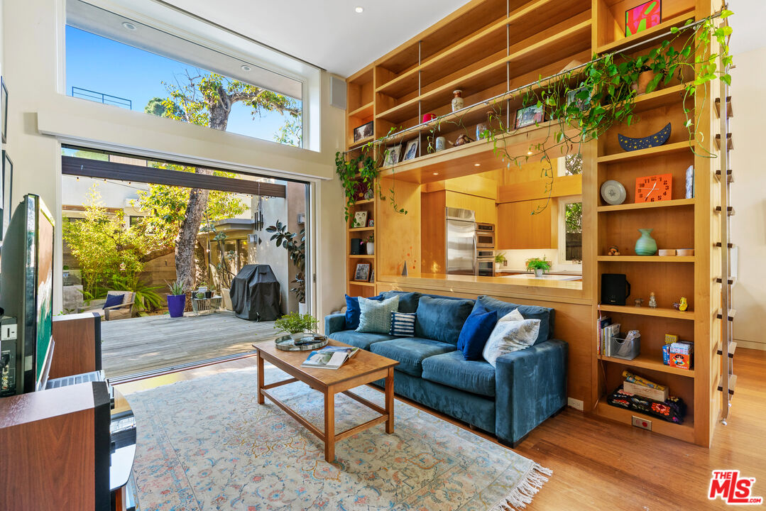 447 Sycamore Road Santa Monica, CA 90402 - Photo 1 of 36 a living room with furniture a rug and a large window