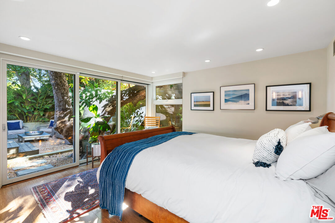 447 Sycamore Road Santa Monica, CA 90402 - Photo 14 of 36 a bedroom with a large bed and a large window