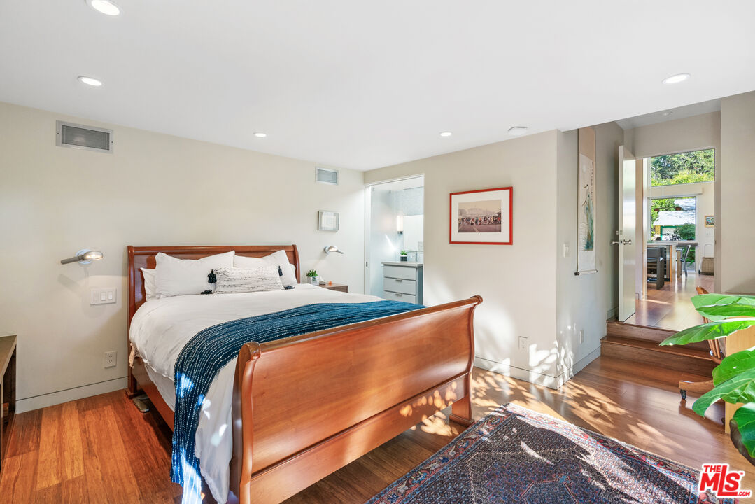 447 Sycamore Road Santa Monica, CA 90402 - Photo 15 of 36 a bed room with a bed and a chair