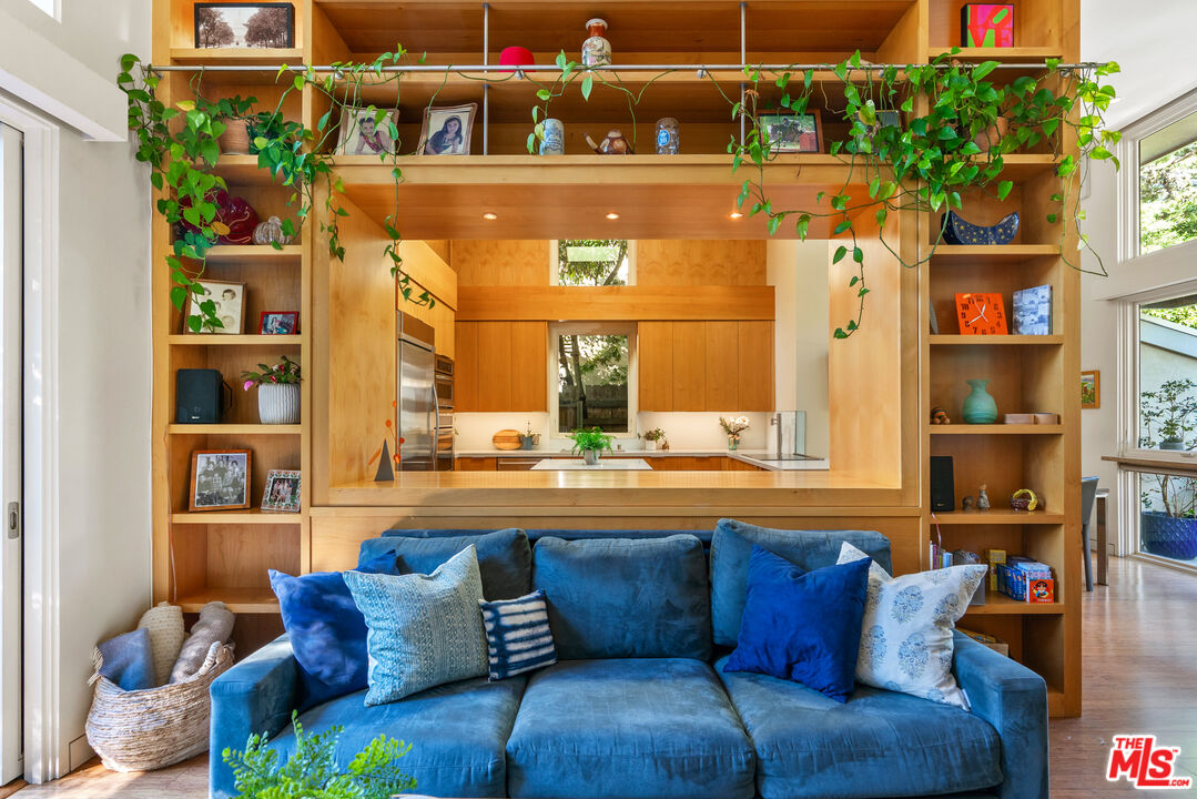 447 Sycamore Road Santa Monica, CA 90402 - Photo 22 of 36 a living room with furniture and a floor to ceiling window