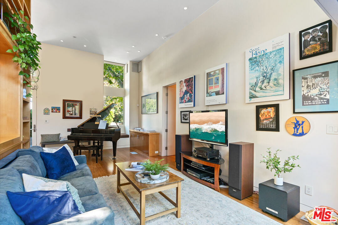 447 Sycamore Road Santa Monica, CA 90402 - Photo 23 of 36 a living room with furniture and a flat screen tv