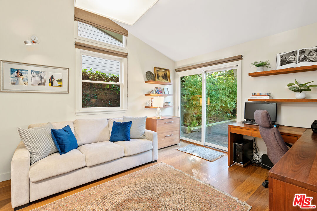 447 Sycamore Road Santa Monica, CA 90402 - Photo 24 of 36 a living room with furniture and a window
