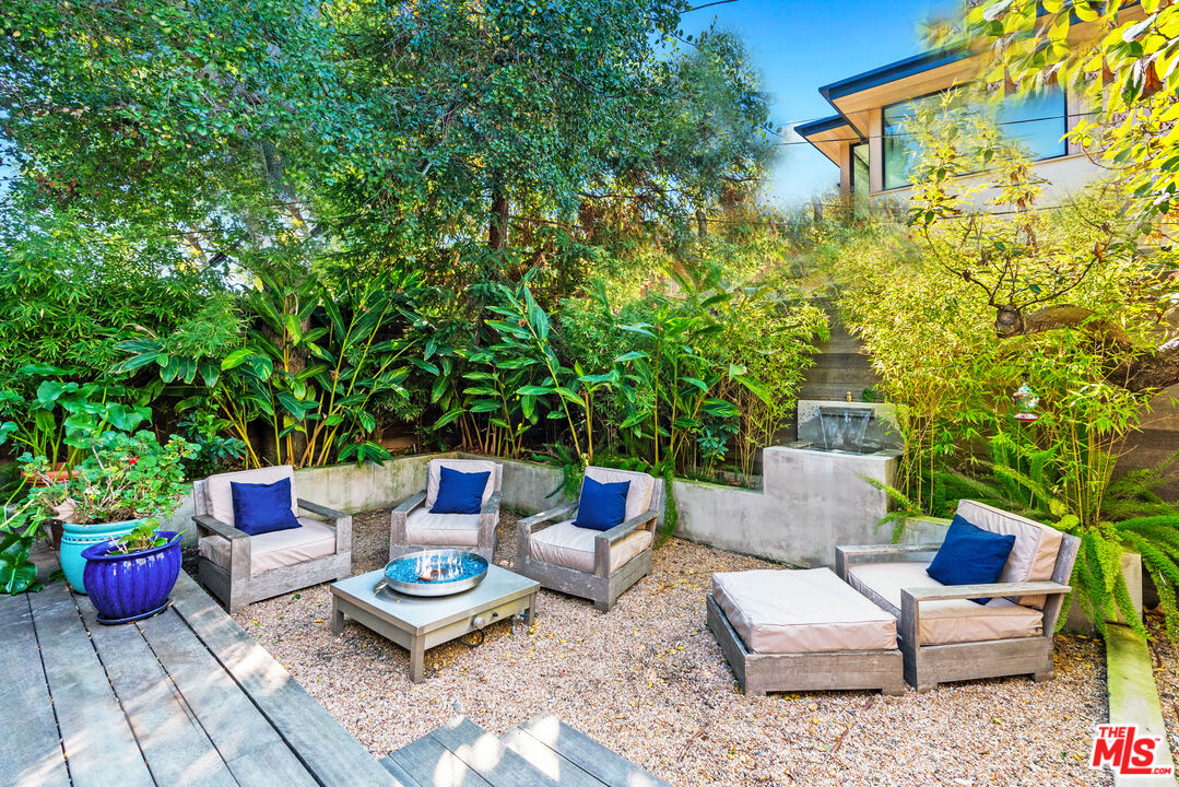 447 Sycamore Road Santa Monica, CA 90402 - Photo 29 of 36 a backyard of a house with couches potted plants and outdoor seating