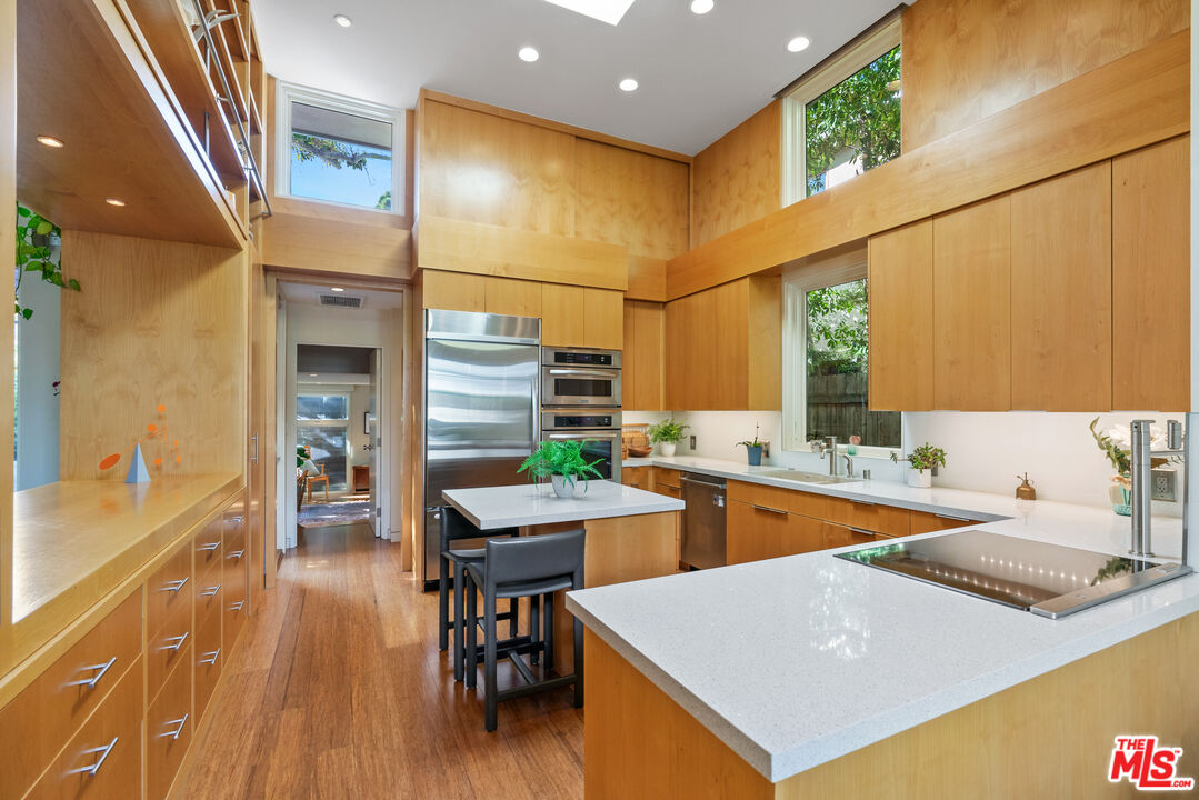 447 Sycamore Road Santa Monica, CA 90402 - Photo 7 of 36 a open kitchen with stainless steel appliances granite countertop a sink and cabinets