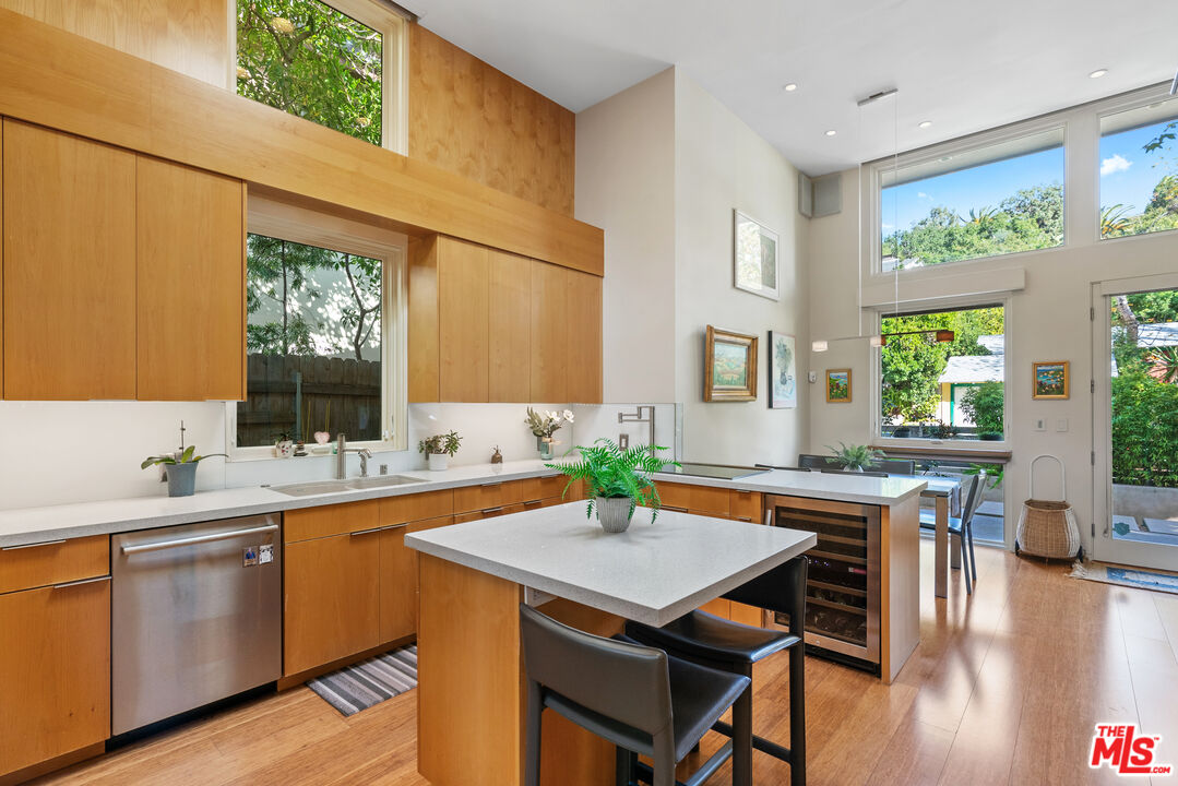 447 Sycamore Road Santa Monica, CA 90402 - Photo 8 of 36 a kitchen with a table chairs sink and cabinets