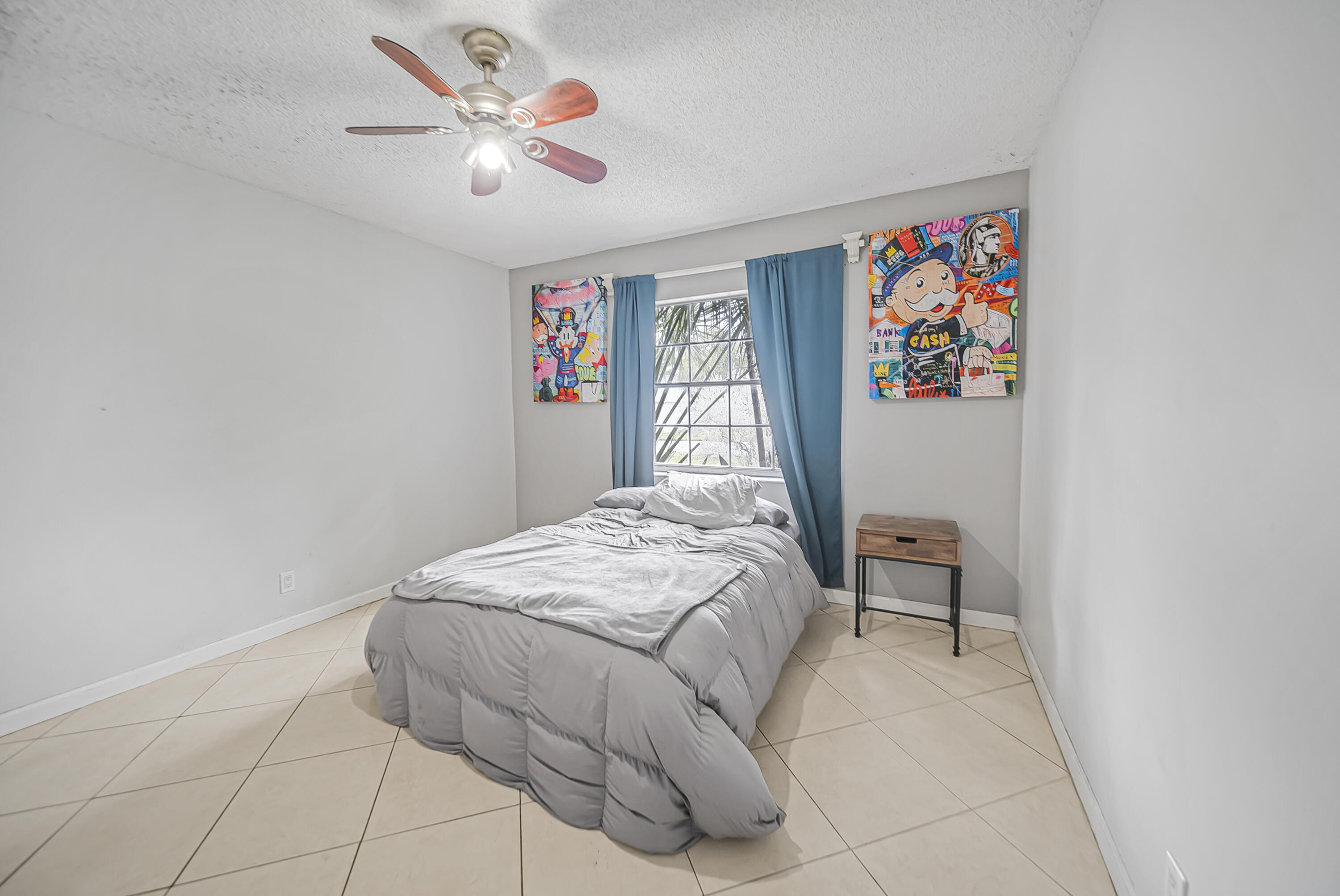 19657 Carolina Circle Boca Raton, FL 33434 - Photo 3 of 8 a bedroom with a bed and a chandelier