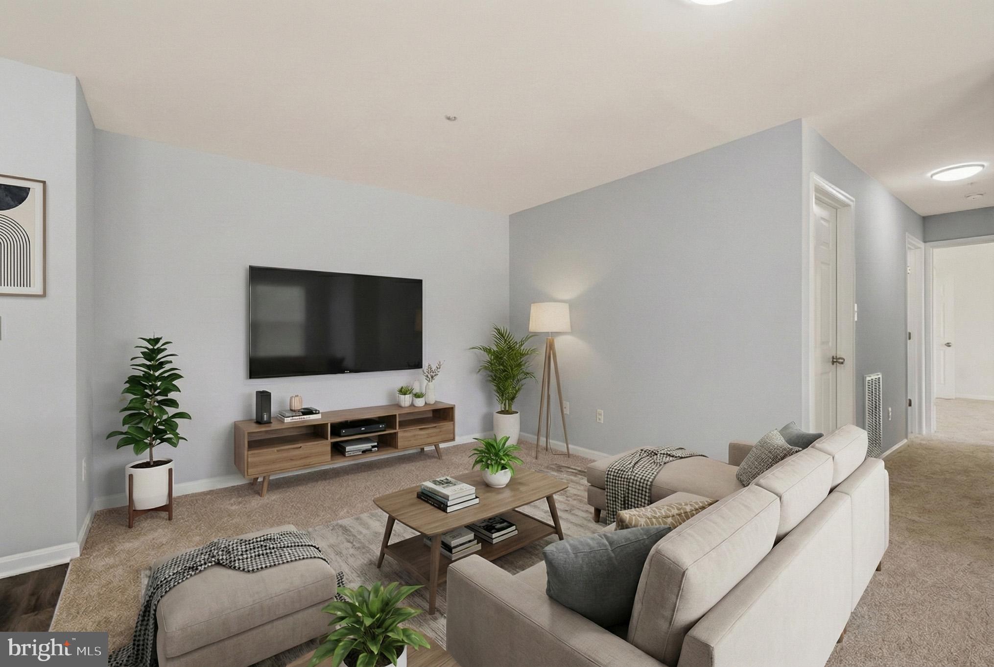 2400 Ellsworth Way, Unit 2D Frederick, MD 21702 - Photo 11 of 34 a living room with furniture and a flat screen tv