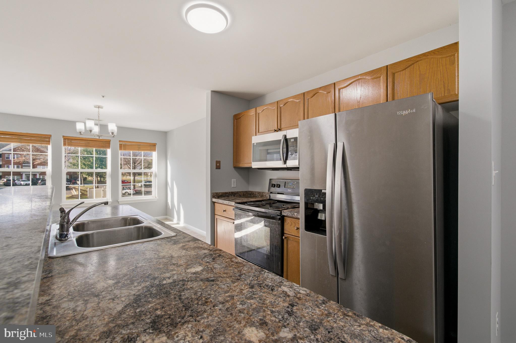 2400 Ellsworth Way, Unit 2D Frederick, MD 21702 - Photo 23 of 34 a kitchen with stainless steel appliances granite countertop a refrigerator and a sink
