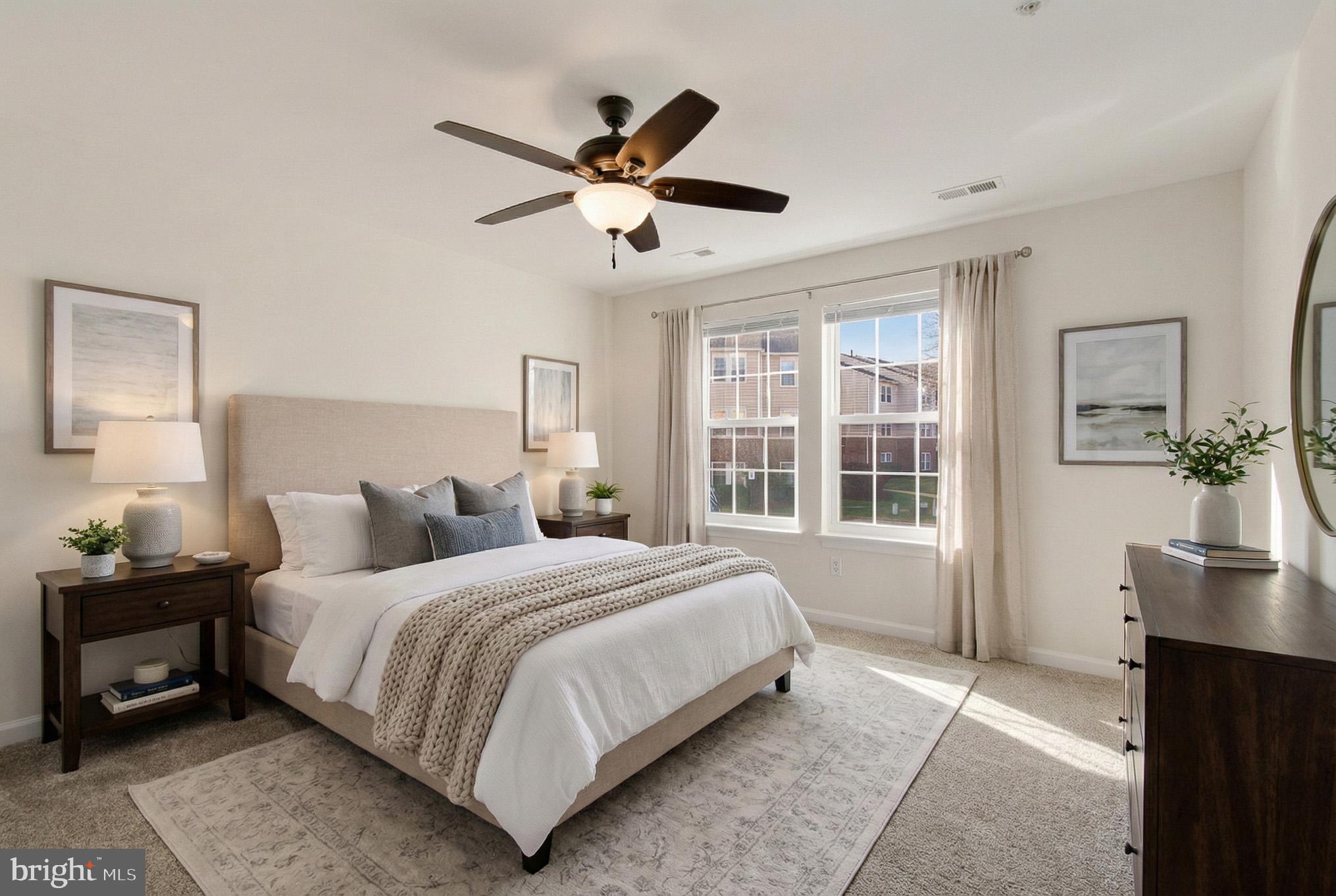 2400 Ellsworth Way, Unit 2D Frederick, MD 21702 - Photo 25 of 34 a bedroom with a large bed and a chandelier