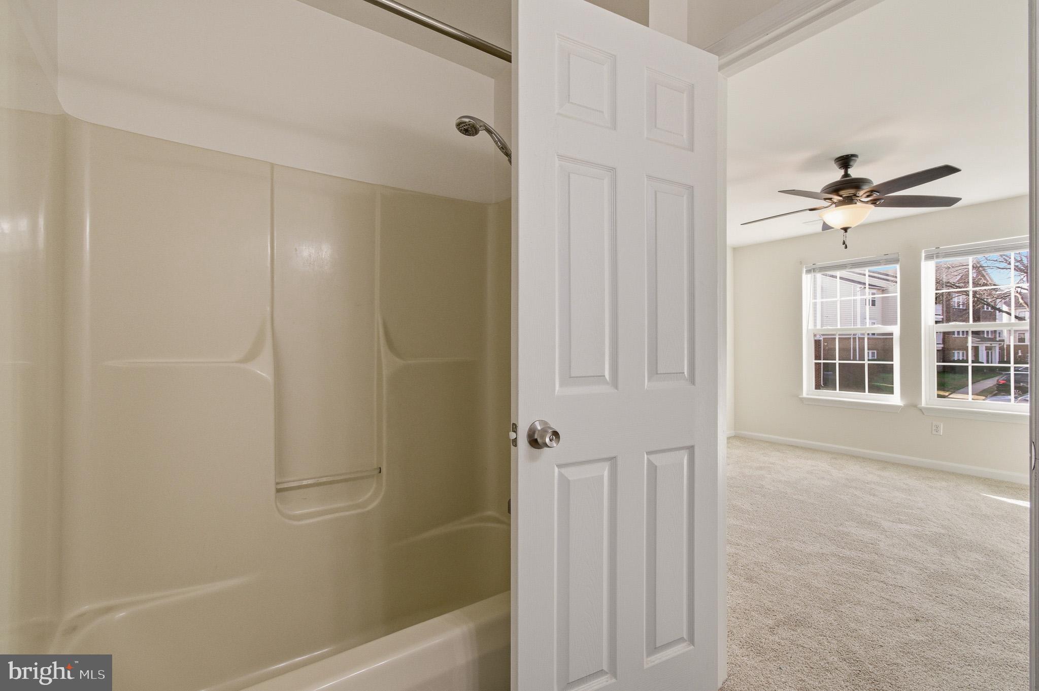 2400 Ellsworth Way, Unit 2D Frederick, MD 21702 - Photo 31 of 34 a view of a bathroom with a glass door shower