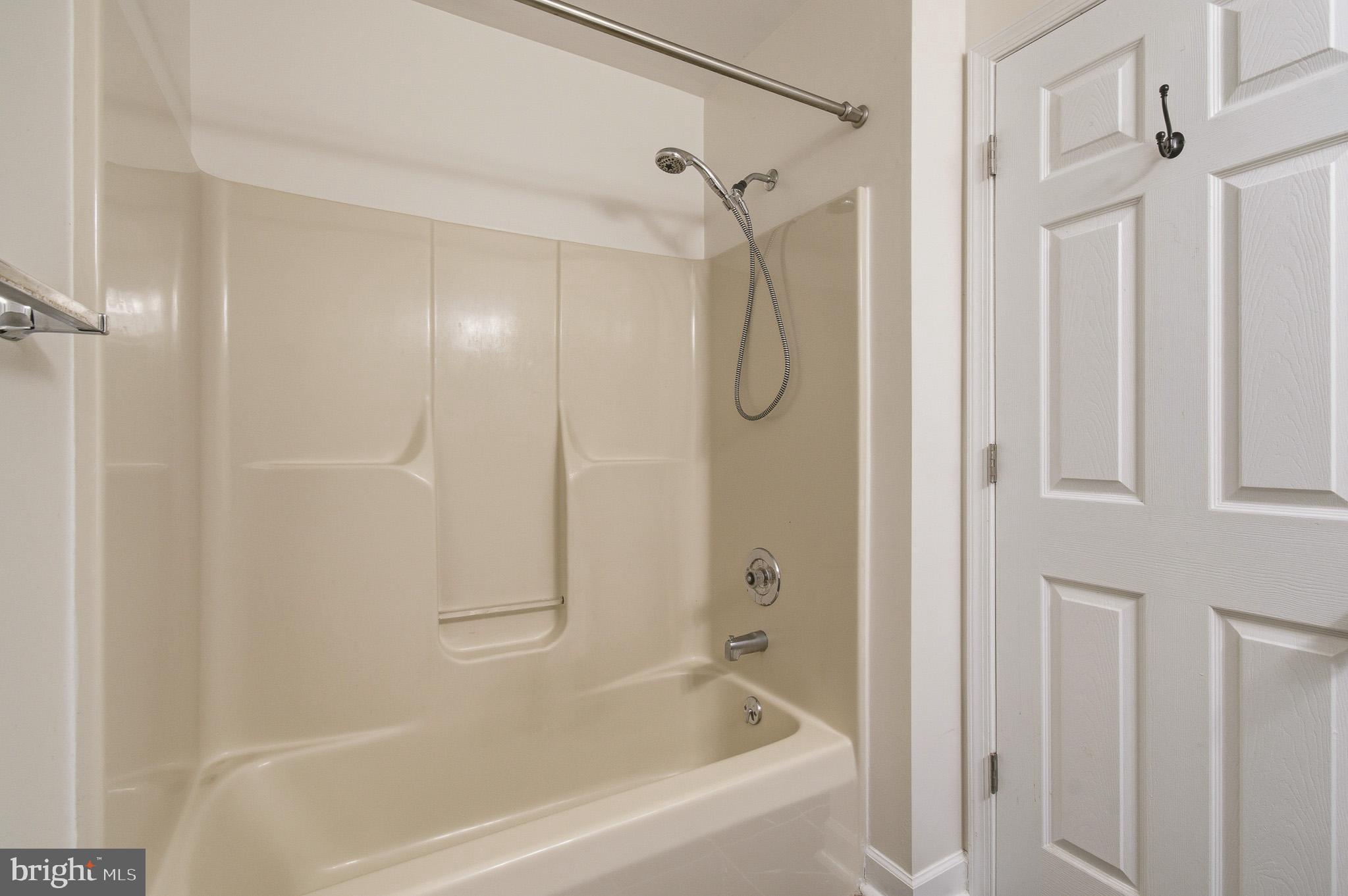 2400 Ellsworth Way, Unit 2D Frederick, MD 21702 - Photo 32 of 34 a bathroom with a shower and a bathtub