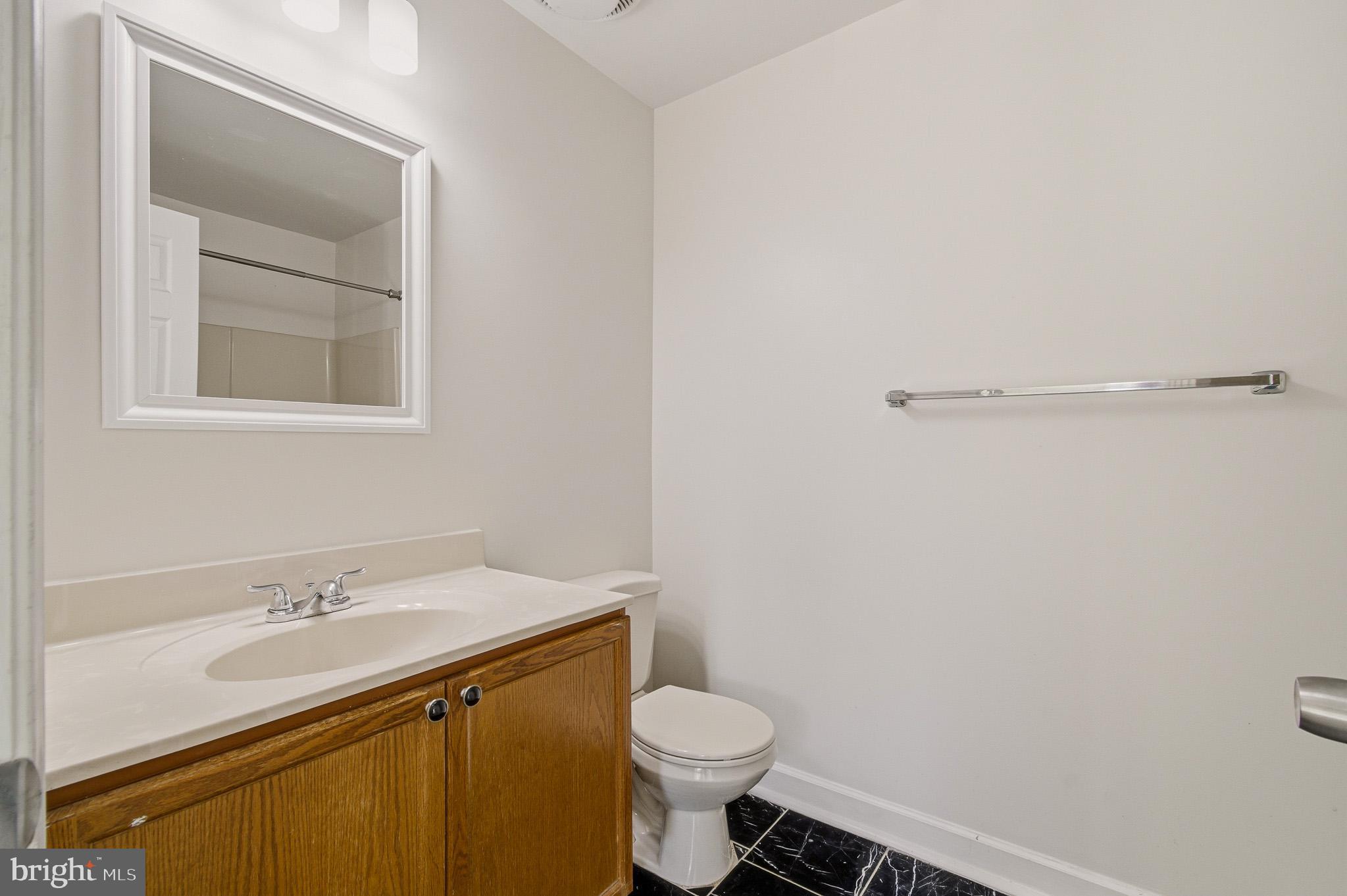 2400 Ellsworth Way, Unit 2D Frederick, MD 21702 - Photo 33 of 34 a bathroom with a sink toilet and vanity