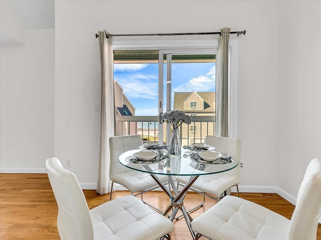 115 Water Street, Unit 14 Beverly, MA 01915 - Photo 11 of 38 a dining room with furniture a rug and wooden floor