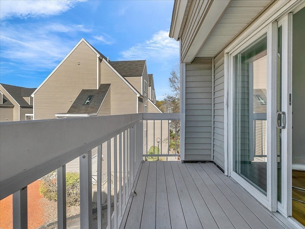 115 Water Street, Unit 14 Beverly, MA 01915 - Photo 13 of 38 a view of balcony with wooden floor and fence