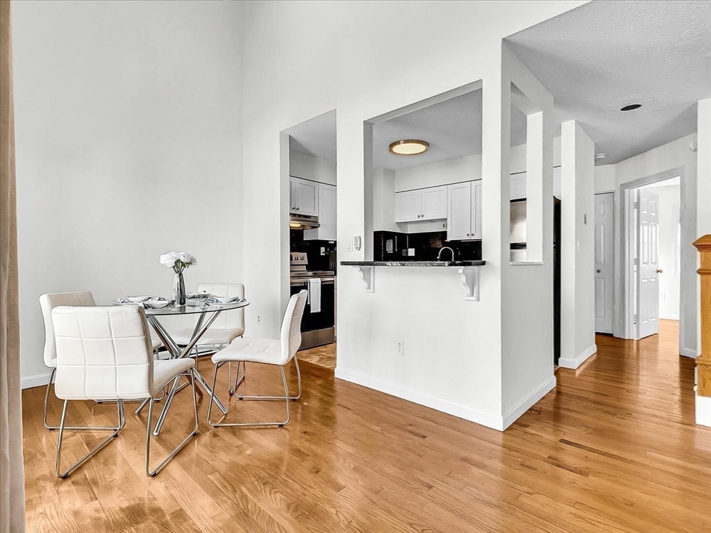 115 Water Street, Unit 14 Beverly, MA 01915 - Photo 15 of 38 a view of a workspace with furniture and wooden floor