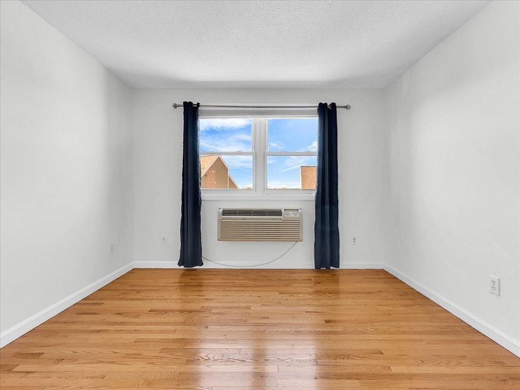 115 Water Street, Unit 14 Beverly, MA 01915 - Photo 26 of 38 a view of empty room with wooden floor