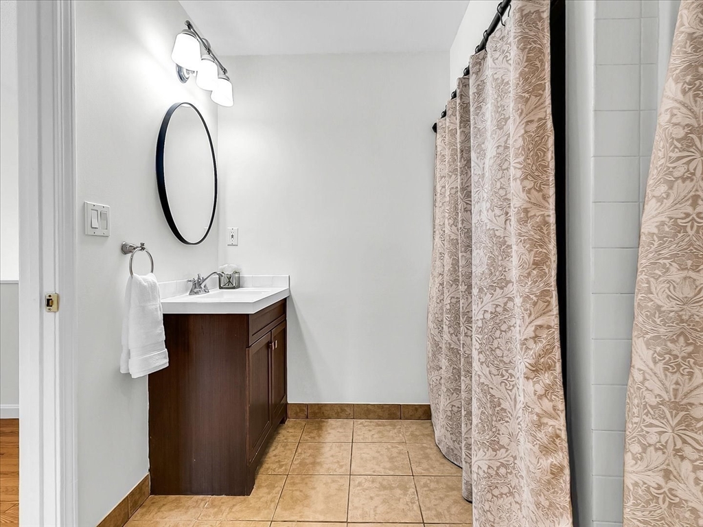 115 Water Street, Unit 14 Beverly, MA 01915 - Photo 29 of 38 a bathroom with a sink and a mirror
