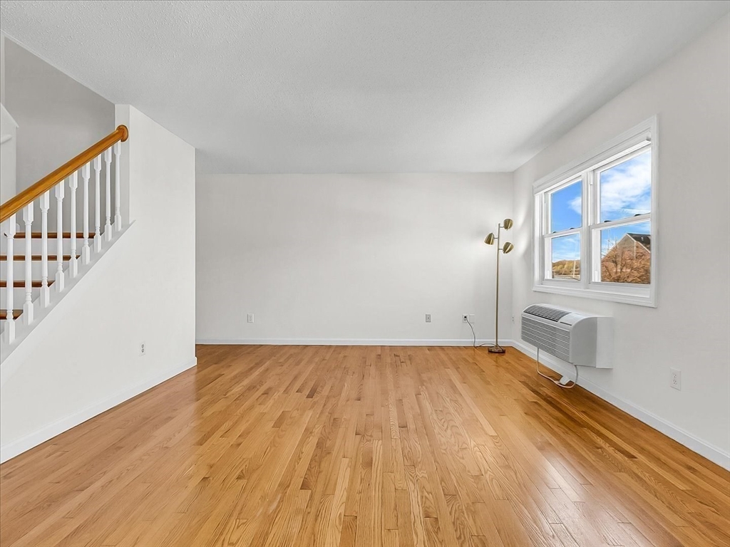 115 Water Street, Unit 14 Beverly, MA 01915 - Photo 7 of 38 a view of a room with wooden floor and white walls