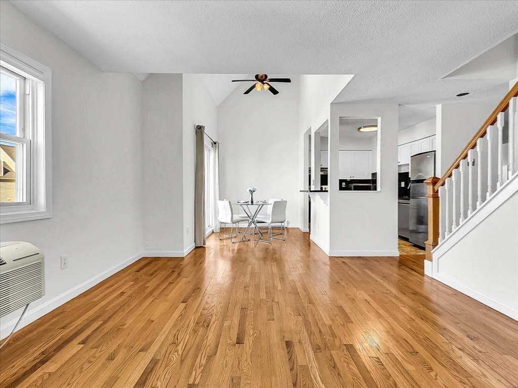 115 Water Street, Unit 14 Beverly, MA 01915 - Photo 9 of 38 a view of a living room with kitchen island wooden floor and a window