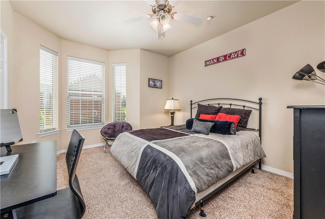 1198 Jones-Butler Road, Unit 2709 College Station, TX 77840 - Photo 10 of 14 a bedroom with a bed and dresser with mirror