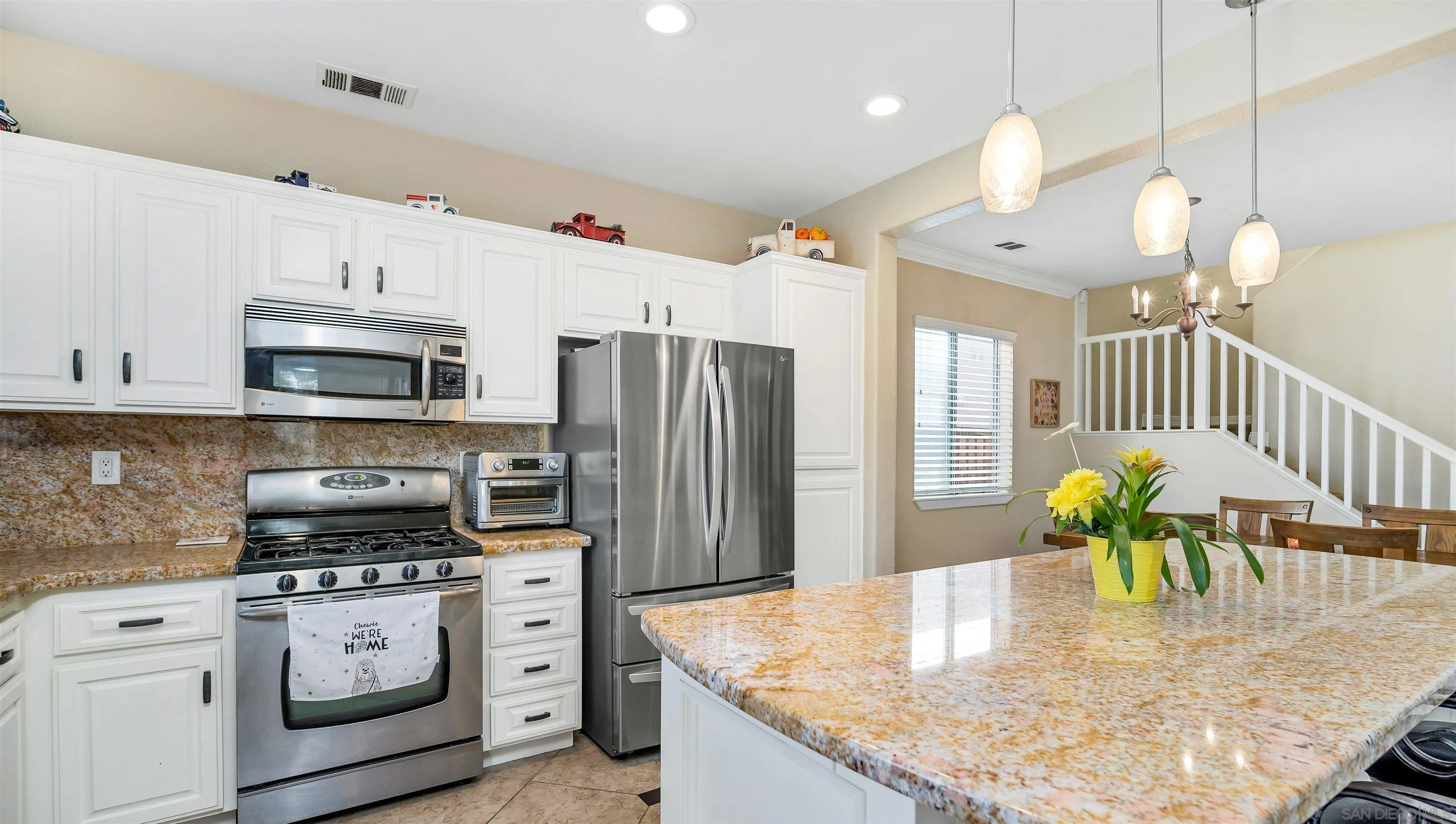 16163 Setting Sun Circle Riverside, CA 92503 - Photo 12 of 45 a kitchen with stainless steel appliances granite countertop a stove a refrigerator a oven a sink with island cabinets and wooden floor