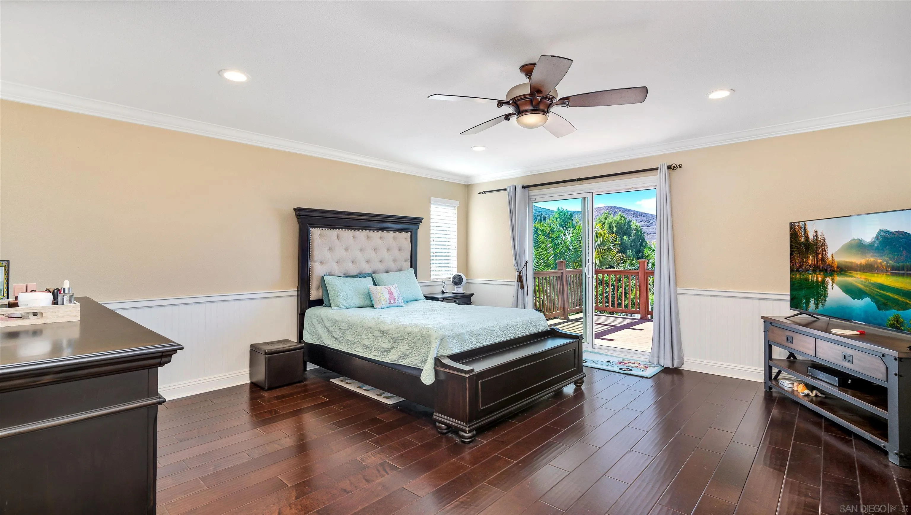 16163 Setting Sun Circle Riverside, CA 92503 - Photo 27 of 45 a bedroom with a bed and a flat screen tv