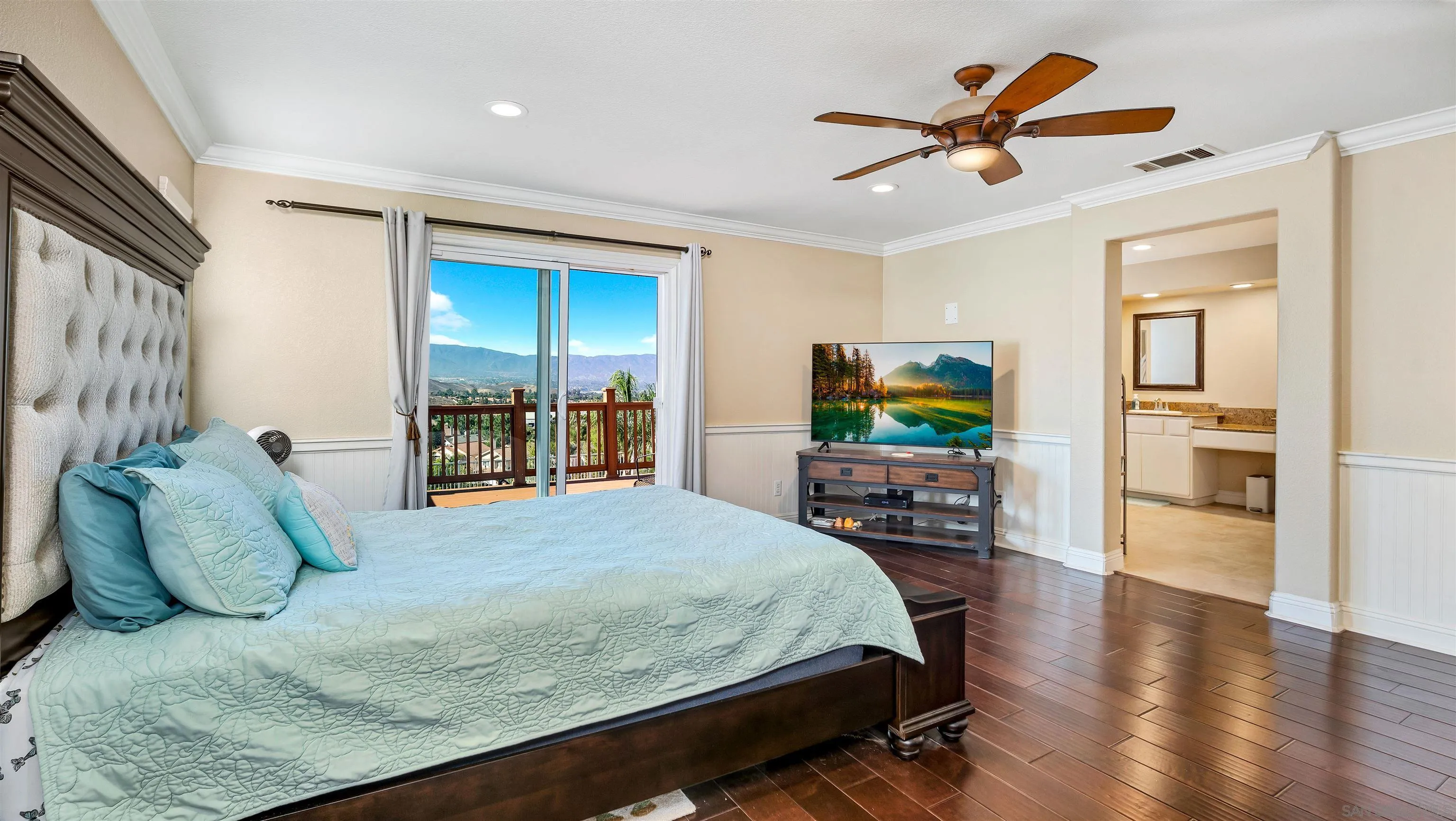 16163 Setting Sun Circle Riverside, CA 92503 - Photo 29 of 45 a bedroom with a bed a large window and flat screen tv