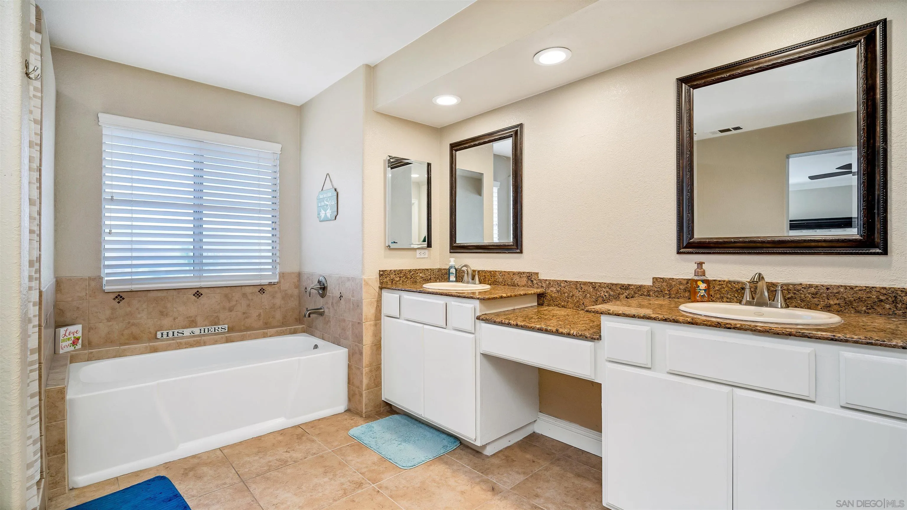 16163 Setting Sun Circle Riverside, CA 92503 - Photo 30 of 45 a bathroom with a tub a sink and a mirror