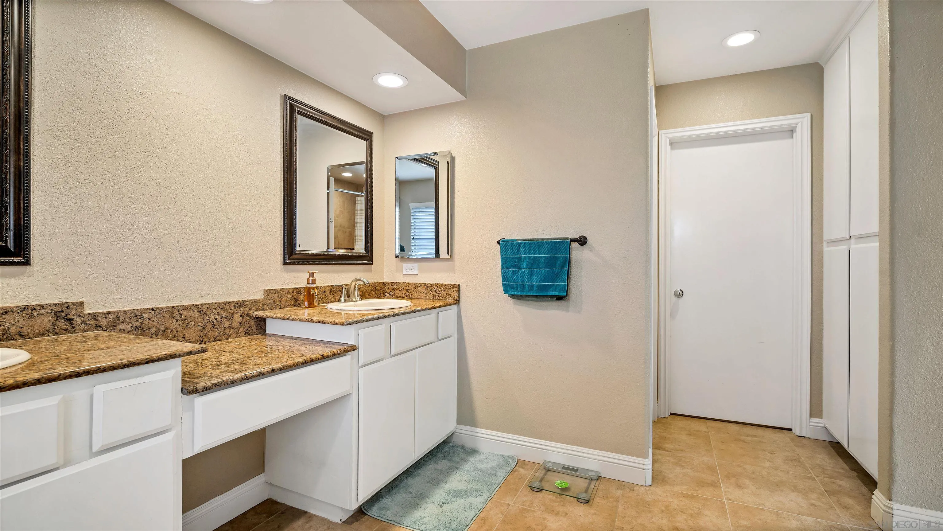 16163 Setting Sun Circle Riverside, CA 92503 - Photo 32 of 45 a bathroom with a granite countertop sink and a mirror
