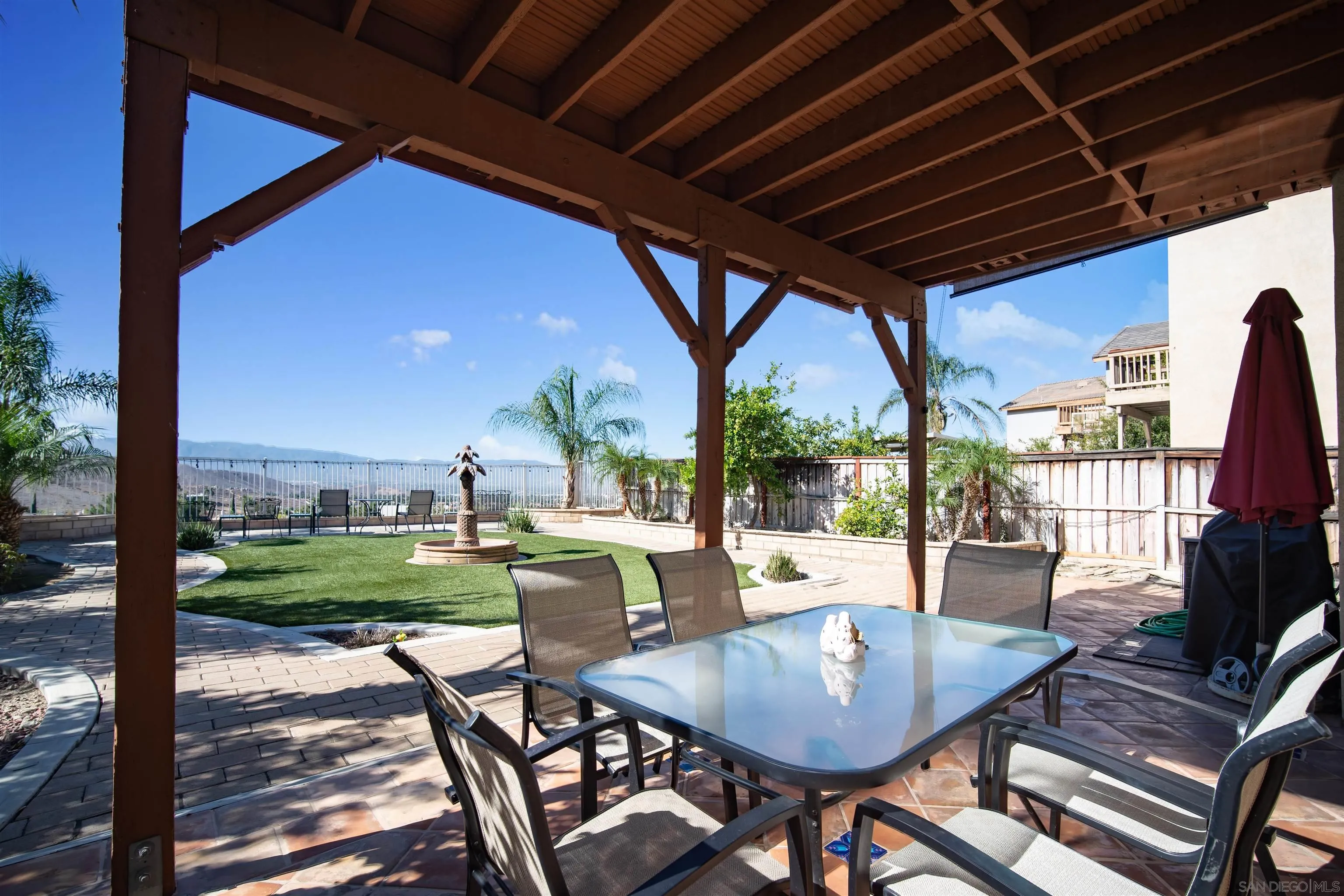16163 Setting Sun Circle Riverside, CA 92503 - Photo 37 of 45 a view of a patio with a table chairs and a backyard