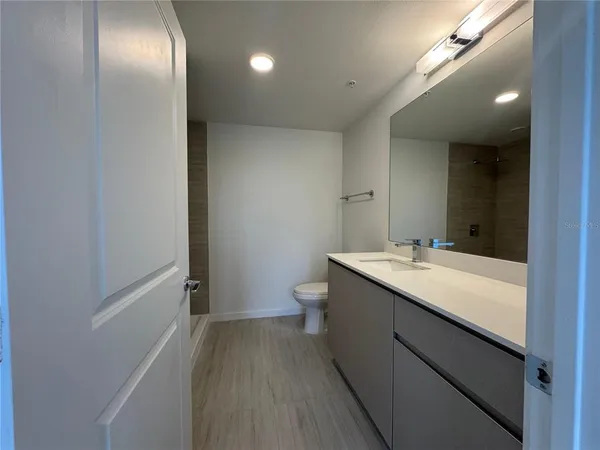 an empty room with windows and closet