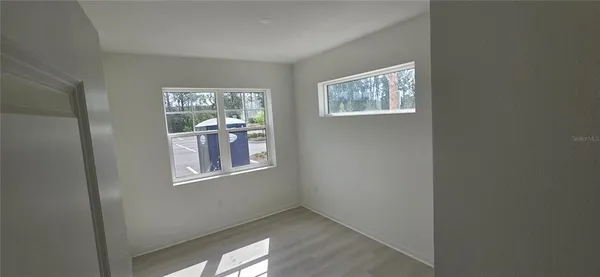 a view of an empty room with closet area