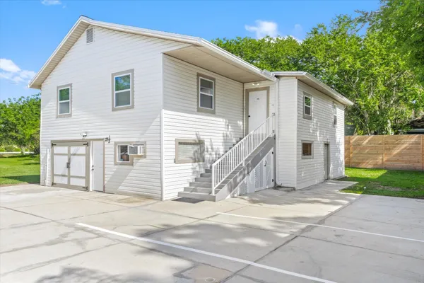 a view of a house with a backyard