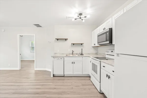 a spacious bathroom with a sink a mirror and a vanity