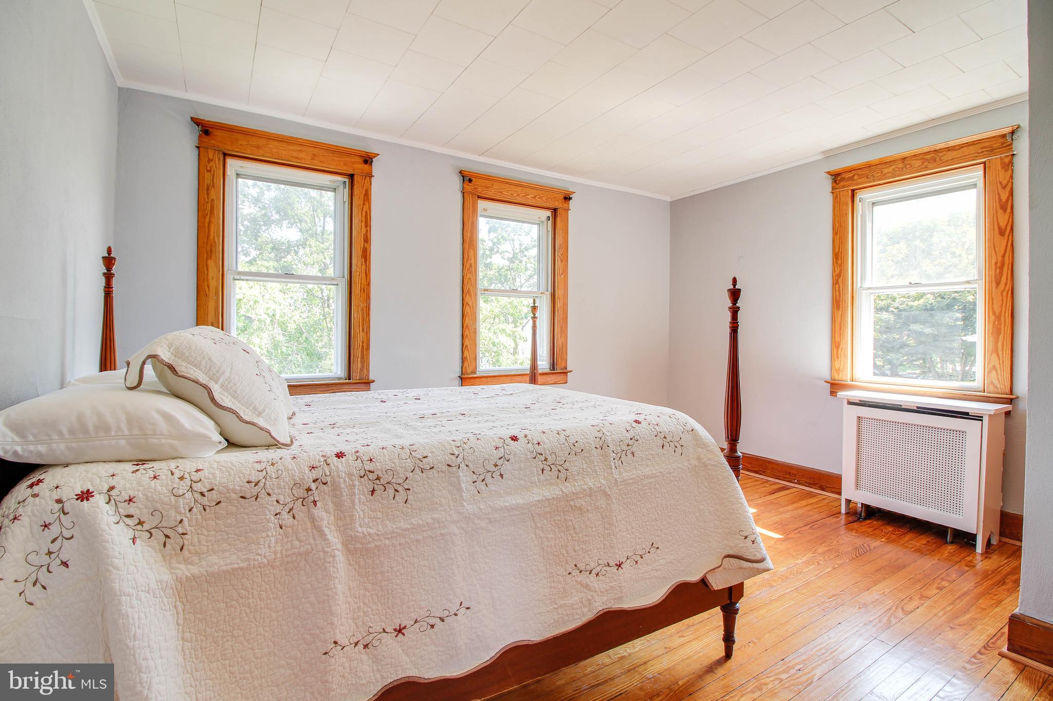 5302 Wendley Road Baltimore, MD 21229 - Photo 16 of 38 a bedroom with a bed and wooden floor