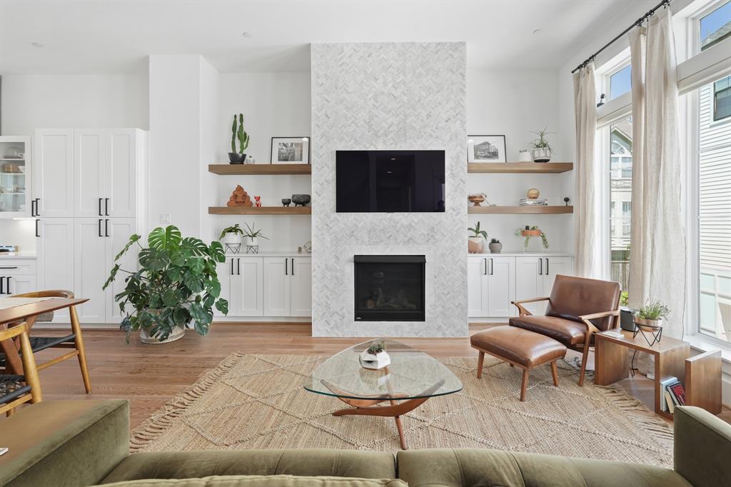 a living room with furniture potted plant and a fireplace